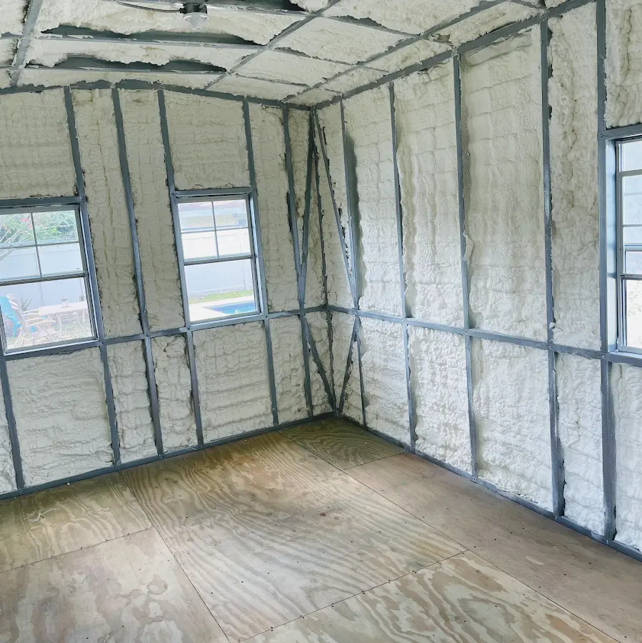 Closed-cell spray foam insulation applied to wall cavities in a residential project in Kingston